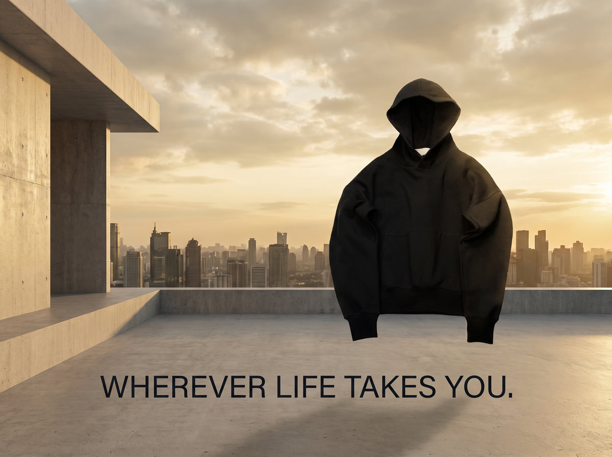 Black hoodie against a warm city skyline.