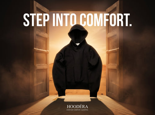 Black HOODÉRA hoodie between open doors. Step Into Comfort.