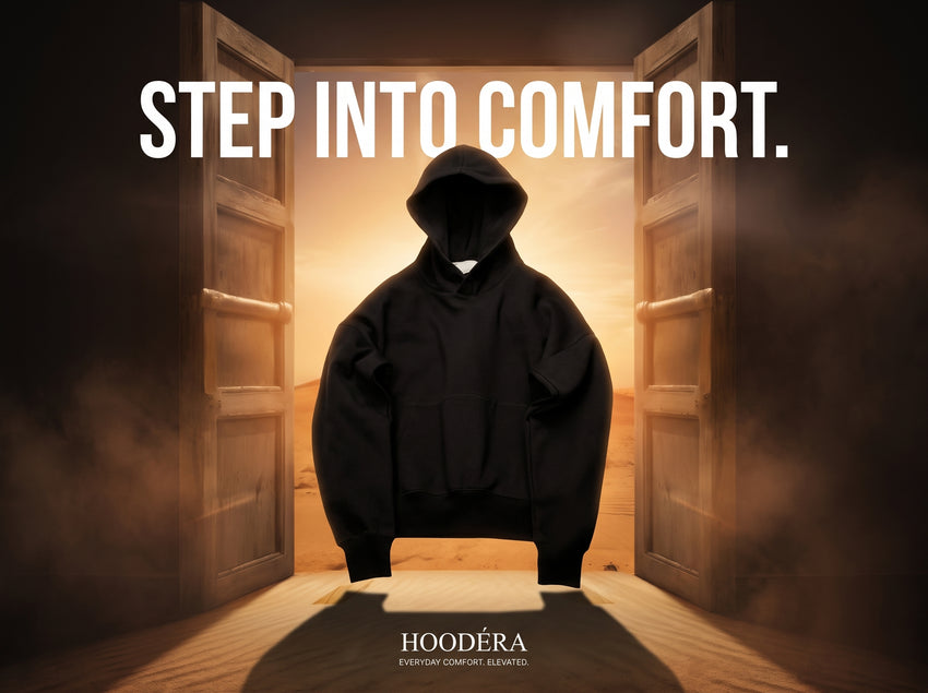 Black HOODÉRA hoodie between open doors. Step Into Comfort.